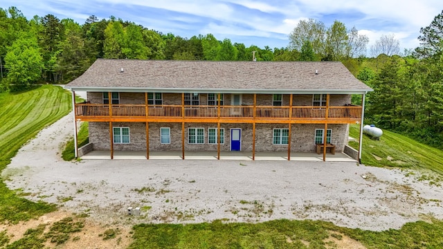 663 John R Jones Rd, London, KY 40741 - back of property featuring a patio area, a wooden deck, and a wooded view
