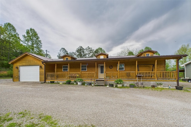 663 John R Jones Rd, London, KY 40741 - view of front of home with covered porch, a garage, driveway, and metal roof