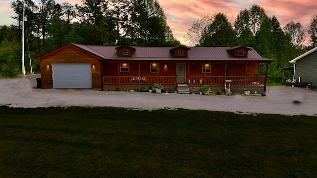 663 John R Jones Rd, London, KY 40741 - view of front facade with covered porch, an attached garage, metal roof, and a yard