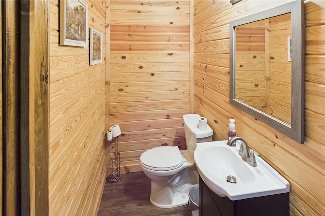 663 John R Jones Rd, London, KY 40741 - bathroom featuring toilet, wooden walls, vanity, and wood finished floors