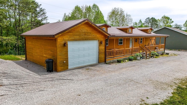 663 John R Jones Rd, London, KY 40741 - rustic home featuring a porch, a garage, metal roof, and driveway