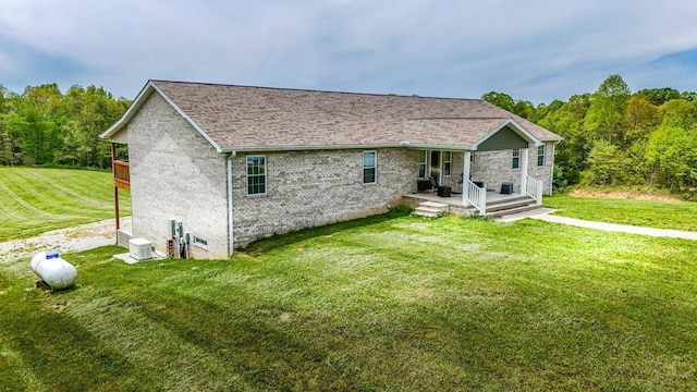 663 John R Jones Rd, London, KY 40741 - rear view of house with brick siding, a lawn, and a porch
