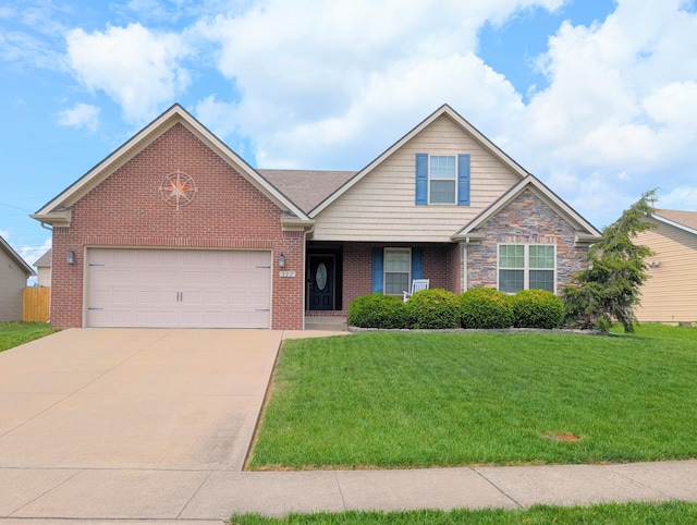view of front of property featuring driveway, a front yard, brick siding, and a garage