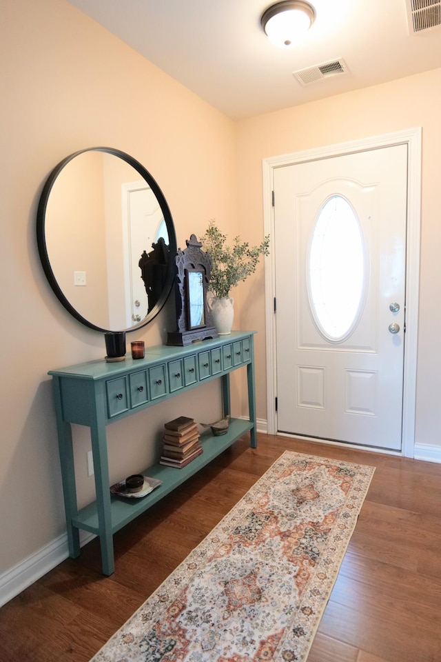 foyer featuring wood finished floors and baseboards