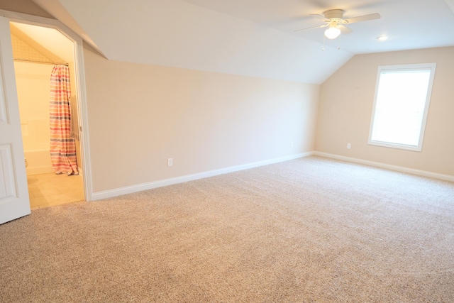 bonus room featuring carpet floors, a ceiling fan, lofted ceiling, and baseboards