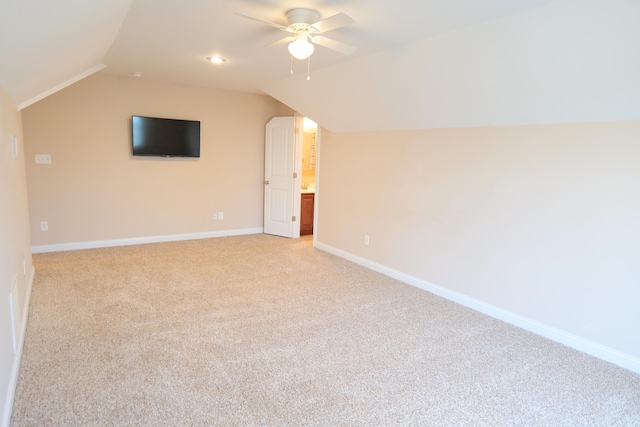additional living space featuring lofted ceiling, light carpet, ceiling fan, and baseboards