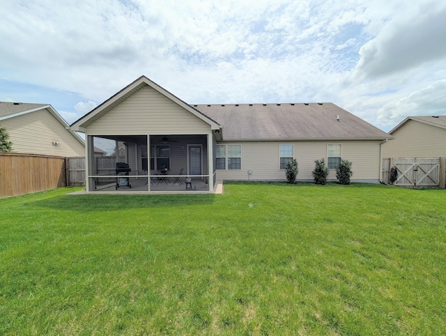rear view of house featuring a sunroom and a ceiling fan