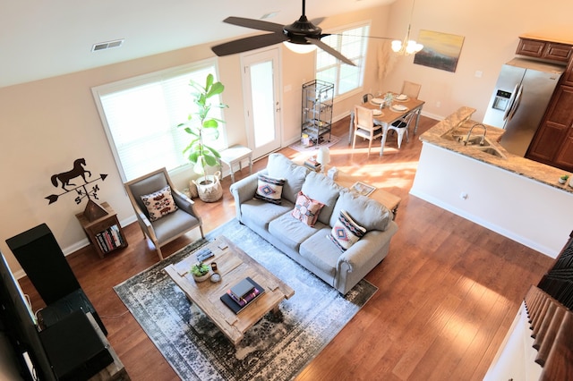 living room featuring wood finished floors, ceiling fan, and baseboards