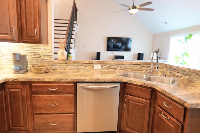 kitchen featuring dishwasher, a sink, tasteful backsplash, ceiling fan, and vaulted ceiling
