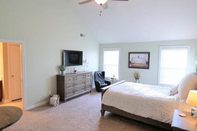 bedroom with high vaulted ceiling, light colored carpet, ceiling fan, and baseboards