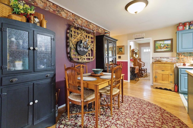 429 Old Danville Rd, Lancaster, KY 40444 - dining space with light wood-style flooring and a wainscoted wall
