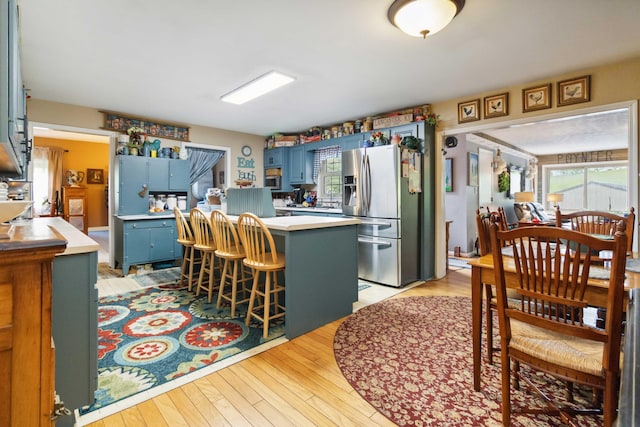 429 Old Danville Rd, Lancaster, KY 40444 - kitchen with stainless steel fridge with ice dispenser, blue cabinets, light countertops, and plenty of natural light