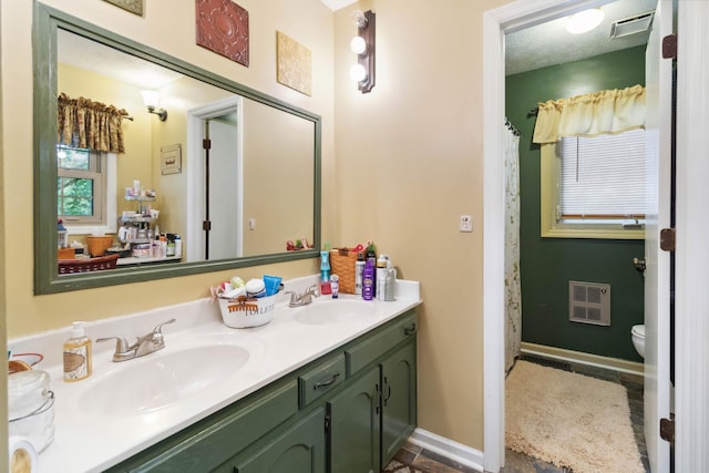 429 Old Danville Rd, Lancaster, KY 40444 - full bath with double vanity, heating unit, toilet, and baseboards