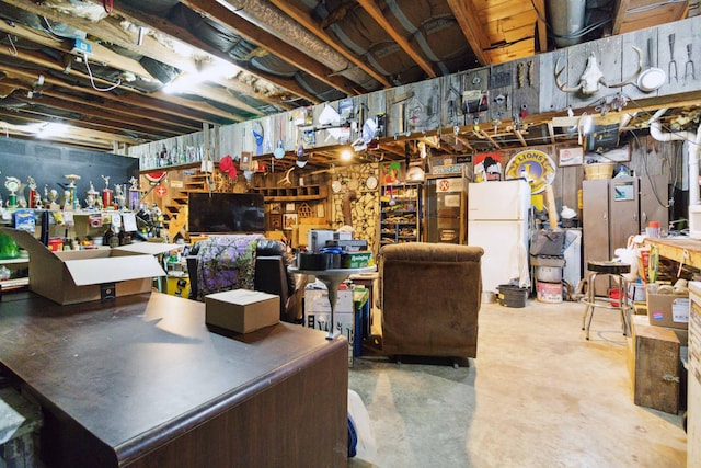 429 Old Danville Rd, Lancaster, KY 40444 - unfinished basement with freestanding refrigerator and a workshop area