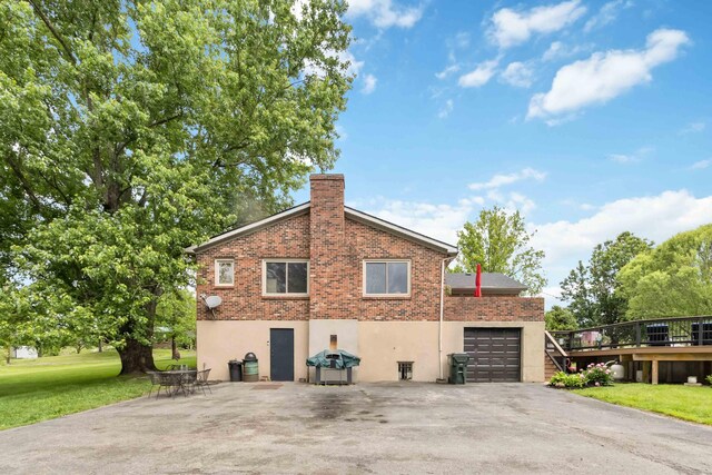 429 Old Danville Rd, Lancaster, KY 40444 - view of side of home featuring a lawn, a chimney, a deck, and stucco siding