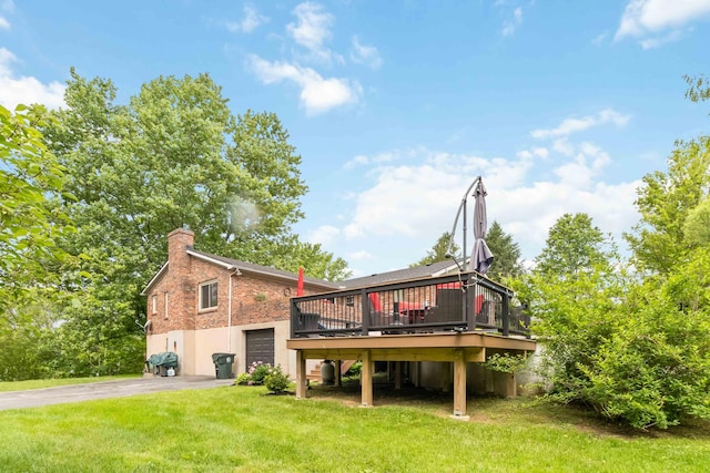 429 Old Danville Rd, Lancaster, KY 40444 - back of property featuring driveway, a wooden deck, a lawn, a chimney, and a garage