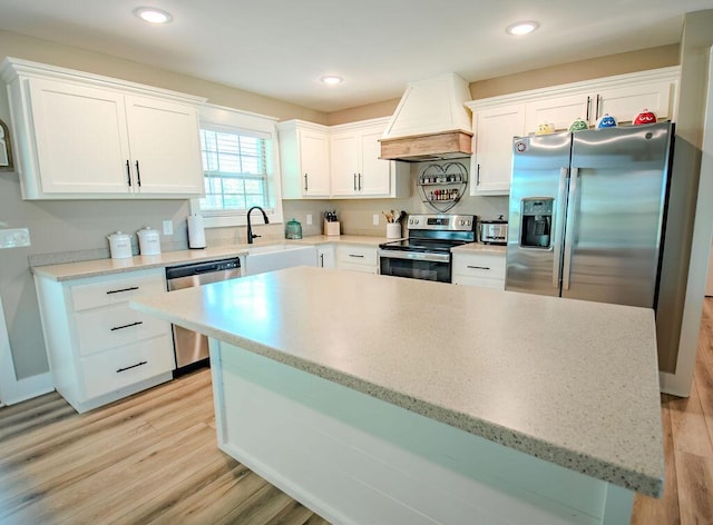 63 Liam Way, Paint Lick, KY 40461 - kitchen with custom range hood, stainless steel appliances, a sink, white cabinetry, and light wood-style flooring