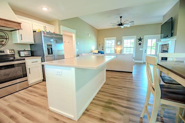 63 Liam Way, Paint Lick, KY 40461 - kitchen featuring appliances with stainless steel finishes, white cabinetry, open floor plan, a ceiling fan, and light wood-style floors