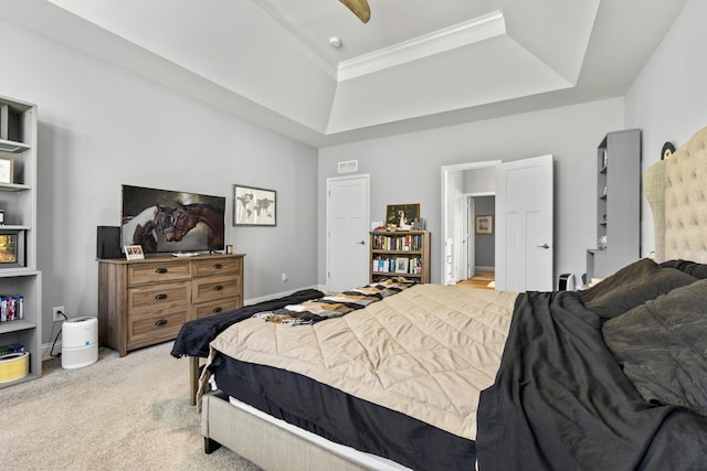 bedroom featuring a raised ceiling, light colored carpet, and crown molding