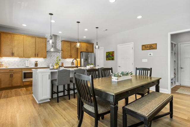 dining area featuring recessed lighting and light wood finished floors