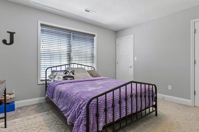 bedroom with carpet floors and baseboards