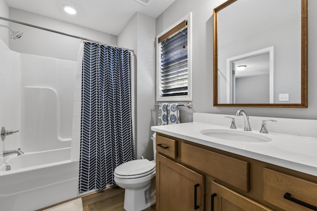 full bathroom featuring toilet, vanity, wood finished floors, and shower / bath combination with curtain