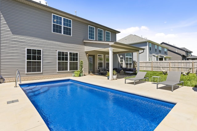 rear view of house with a patio area, fence, and an outdoor living space