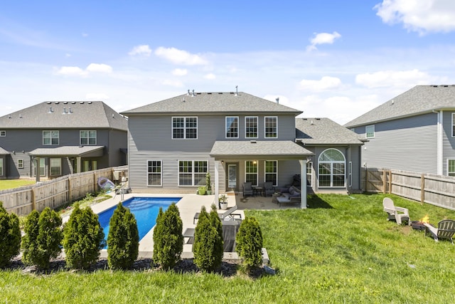 rear view of property featuring a patio and a shingled roof