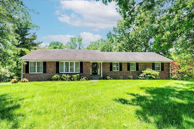 single story home featuring a front yard and brick siding