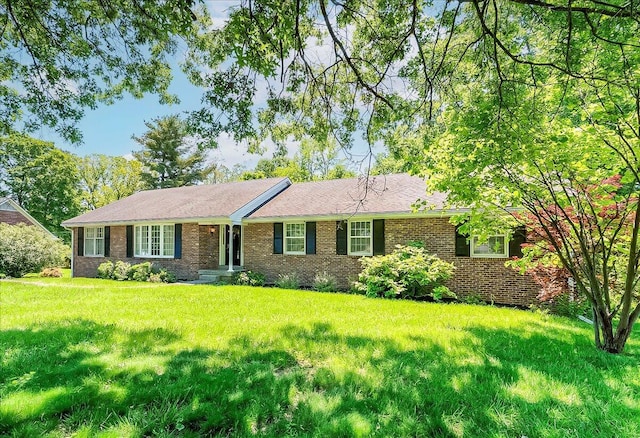 single story home featuring brick siding and a front lawn