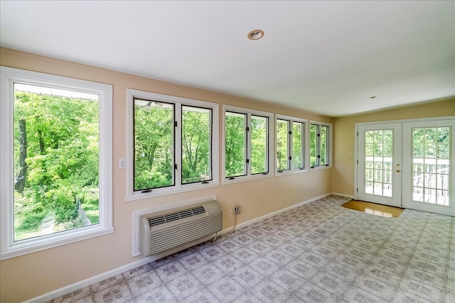 doorway to outside with a wall mounted AC, baseboards, french doors, and carpet