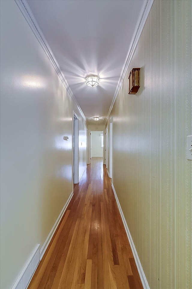 hallway with hardwood / wood-style flooring and baseboards