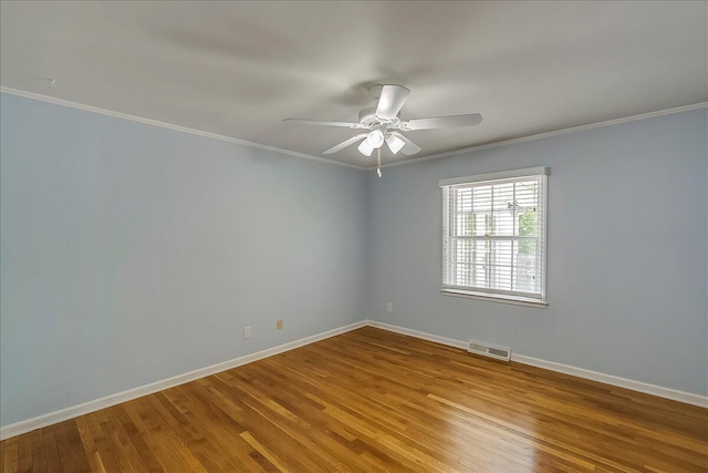 unfurnished room with wood finished floors, baseboards, crown molding, and ceiling fan