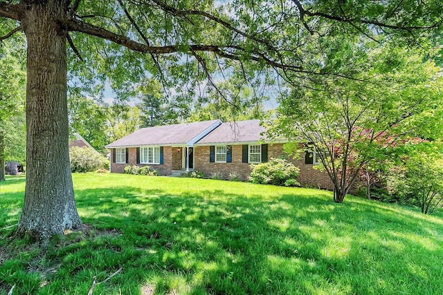ranch-style house with brick siding and a front lawn