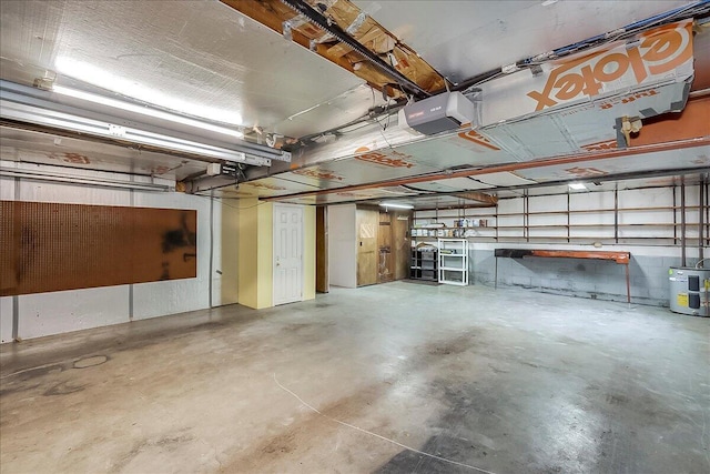 garage featuring a garage door opener and electric water heater