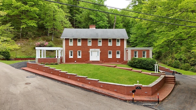 118 Timber Ln, Morehead, KY 40351 - colonial house with a chimney, a view of trees, a front lawn, brick siding, and entry steps