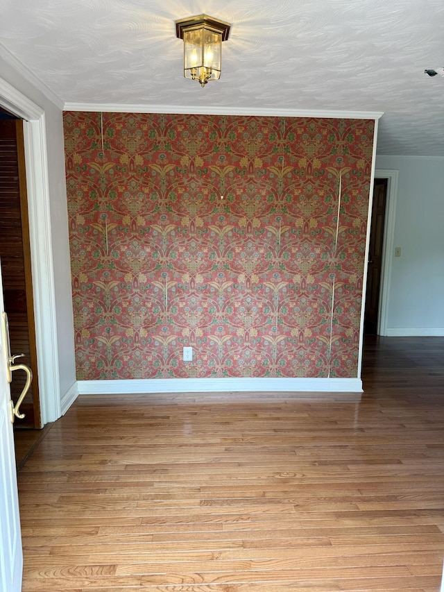 118 Timber Ln, Morehead, KY 40351 - spare room featuring light wood finished floors, baseboards, wallpapered walls, and crown molding