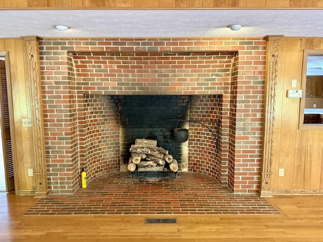 118 Timber Ln, Morehead, KY 40351 - detailed view of wood finished floors, wood walls, a textured ceiling, and baseboards