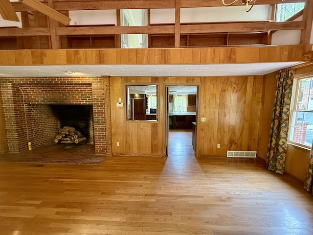 118 Timber Ln, Morehead, KY 40351 - unfurnished living room featuring hardwood / wood-style flooring, wood walls, and a fireplace with flush hearth