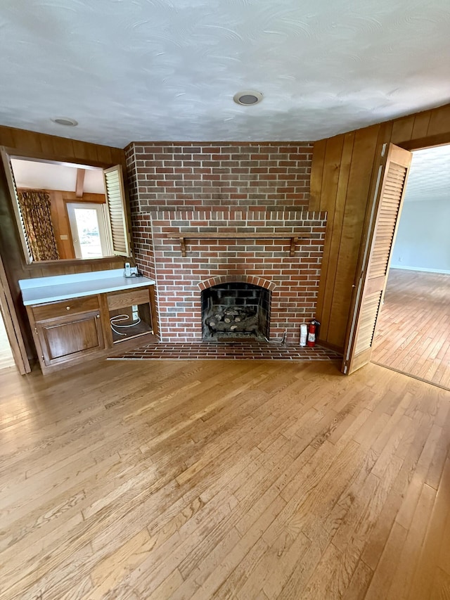 118 Timber Ln, Morehead, KY 40351 - unfurnished living room with hardwood / wood-style flooring, a fireplace, and wood walls