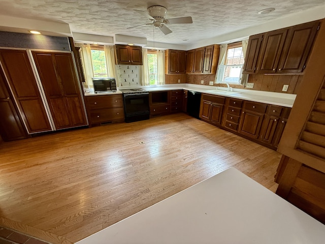 118 Timber Ln, Morehead, KY 40351 - kitchen featuring black appliances, light countertops, light wood-type flooring, a sink, and a ceiling fan
