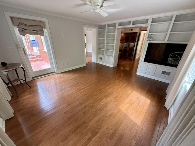 118 Timber Ln, Morehead, KY 40351 - unfurnished living room featuring ornamental molding, built in shelves, baseboards, wood finished floors, and a ceiling fan