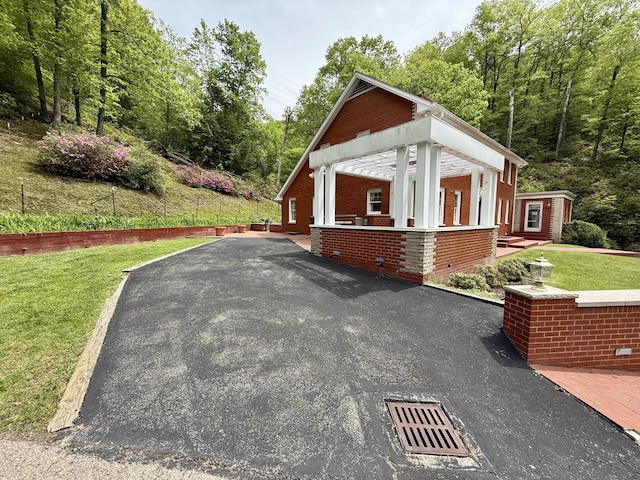 118 Timber Ln, Morehead, KY 40351 - view of property exterior featuring brick siding, a yard, and asphalt driveway