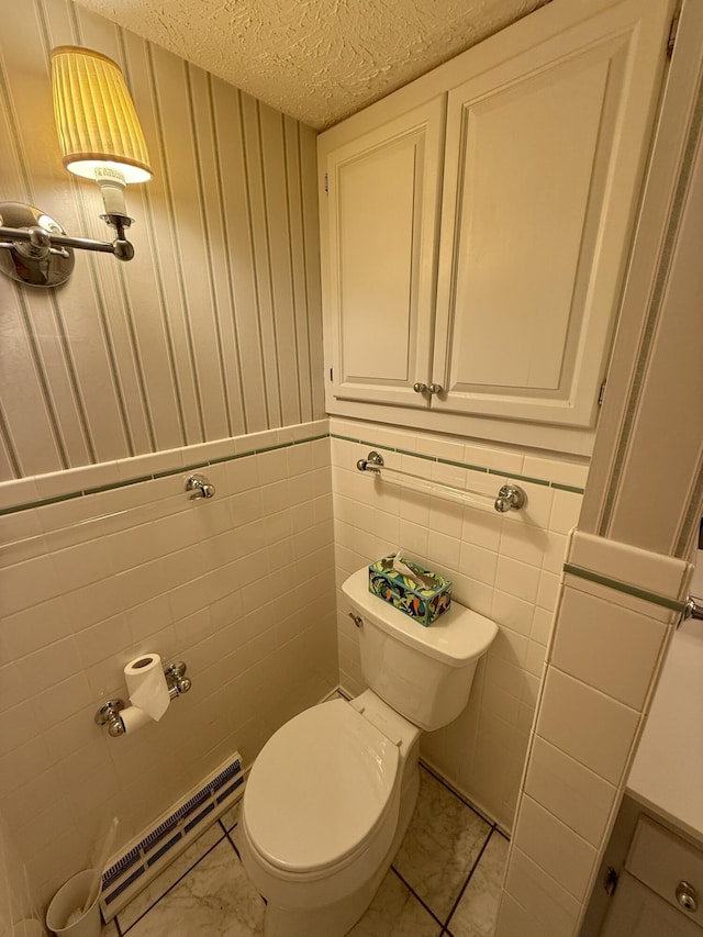 118 Timber Ln, Morehead, KY 40351 - bathroom with baseboard heating, a textured ceiling, toilet, and marble look tiles