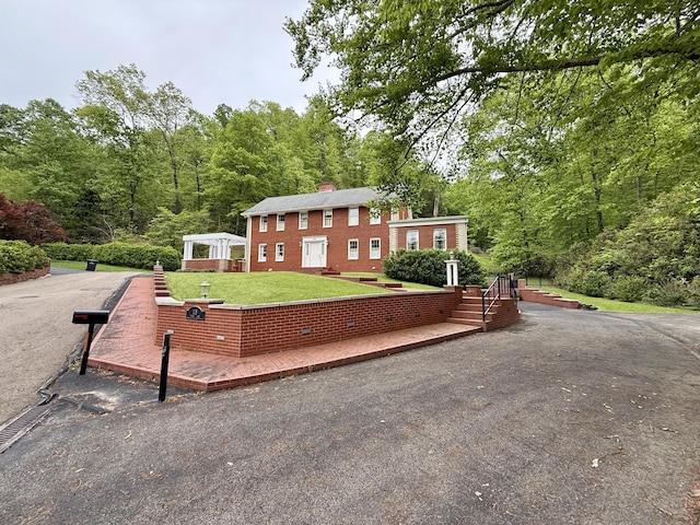 118 Timber Ln, Morehead, KY 40351 - view of front facade featuring a chimney, a front lawn, and a view of trees