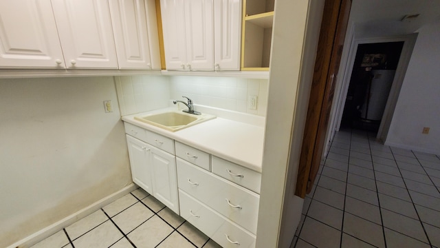 118 Timber Ln, Morehead, KY 40351 - laundry area with a sink, light tile patterned flooring, water heater, and baseboards