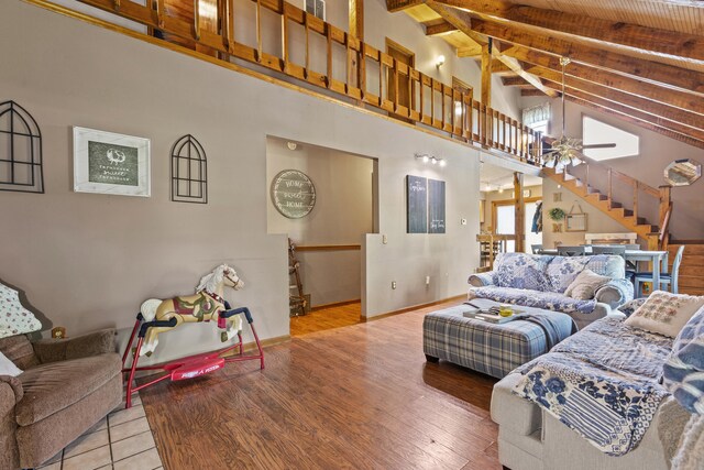 285 W Railroad St, Stanton, KY 40380 - living room featuring ceiling fan, high vaulted ceiling, stairs, beamed ceiling, and wood finished floors