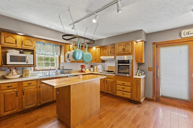 285 W Railroad St, Stanton, KY 40380 - kitchen featuring white appliances, rail lighting, a sink, a center island, and under cabinet range hood