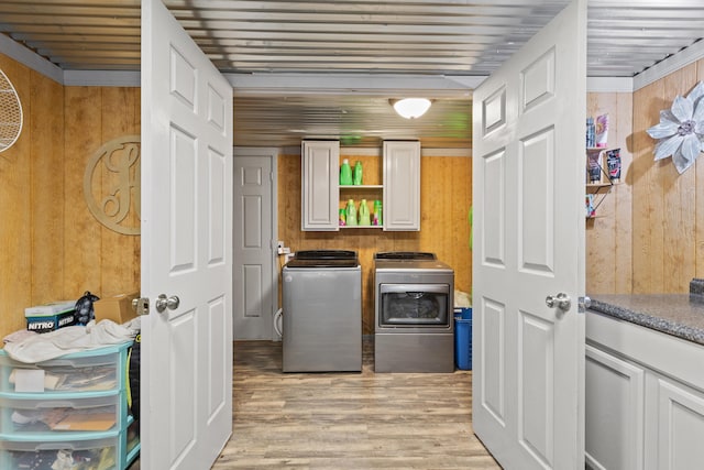 285 W Railroad St, Stanton, KY 40380 - washroom with wooden walls, cabinet space, washer and clothes dryer, and light wood-type flooring
