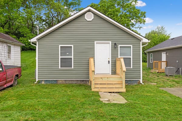 426 Cardwell Ave, Harrodsburg, KY 40330 - rear view of house with a lawn and central AC
